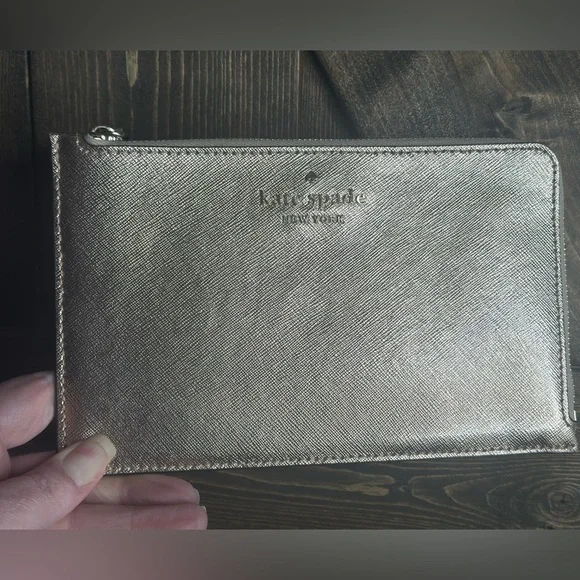 Kate Spade Gold Metallic wristlet
Pre-loved -good condition - Picture 1 of 5